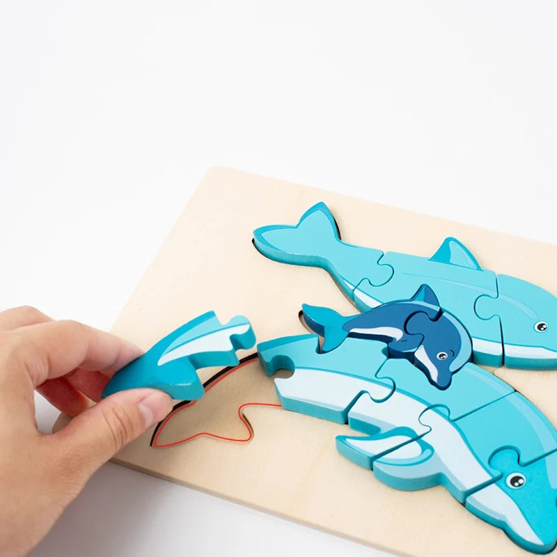 Child's hands fitting the dolphin puzzle pieces together