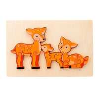 Wooden deer family puzzle with mother and fawn pieces on a light tray