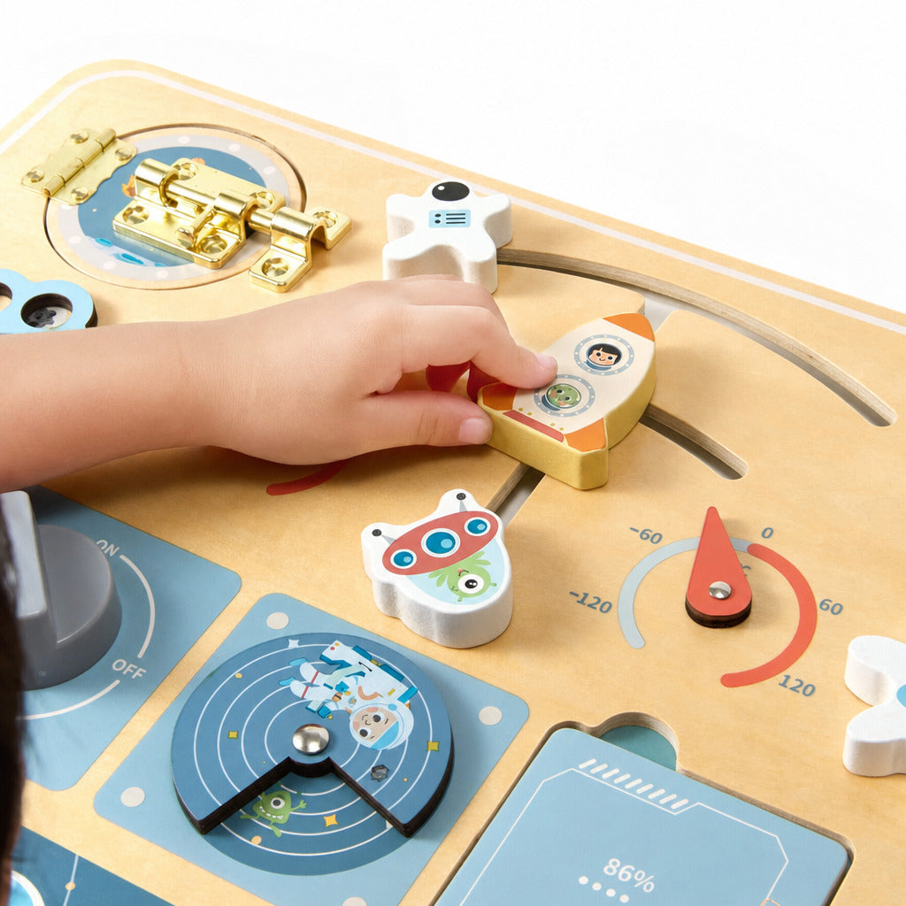 Toddler turning the brass latch on the space activity board