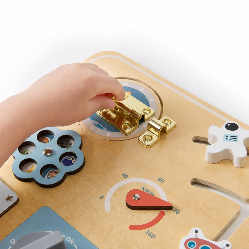 Small hand working the lock and gauge on the space busy board