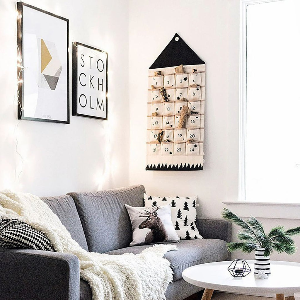Advent calendar hanging in a living room above a grey sofa