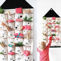 Fabric advent calendar hung on a wall with a child reaching for a pocket