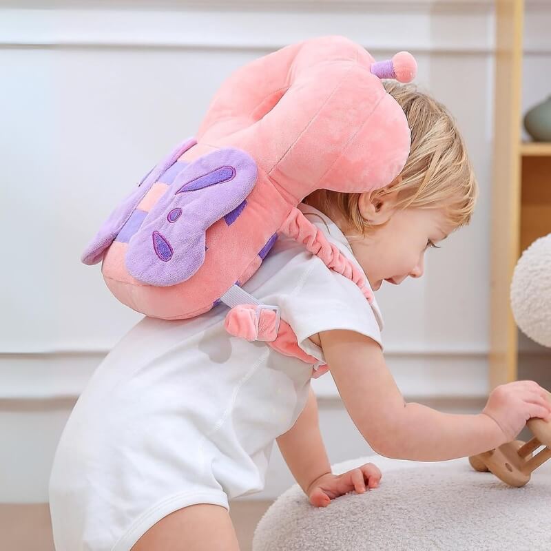 Baby crawling while wearing the pink butterfly head protector