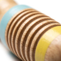 Close-up of the wooden rainstick's ridged pastel body
