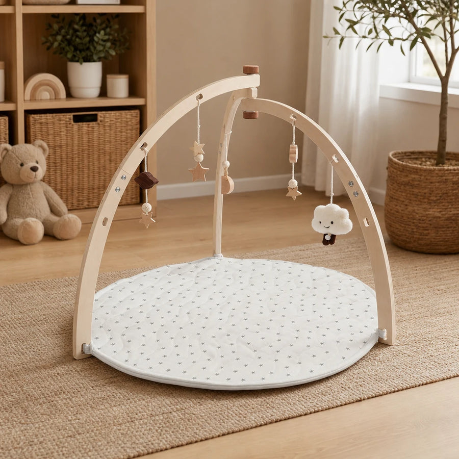 Baby Play Gym Wooden Arch & Mat set out on a real table at home