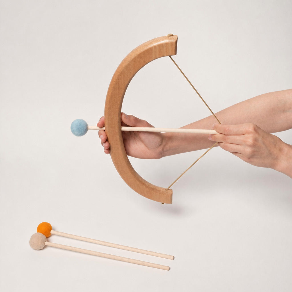 Child drawing the wooden bow with a soft ball-tipped arrow