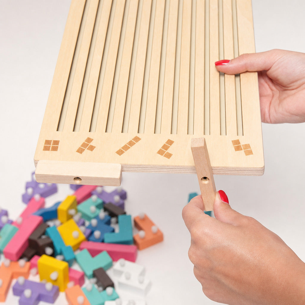 Hand sliding the wooden tetris board over the coloured puzzle blocks