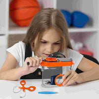 Girl examining a specimen through the bug catcher's magnifier