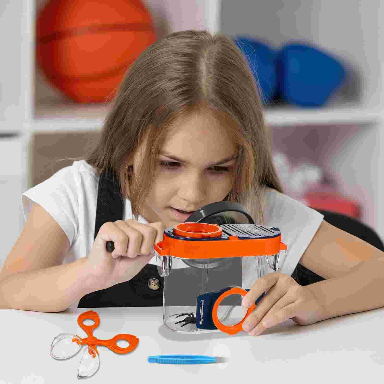 Girl examining a specimen through the bug catcher's magnifier