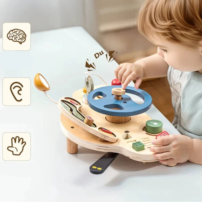 Toddler playing at the wooden activity dashboard on legs