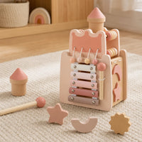 Castle Xylophone Toy with Shape Sorter & Hammer set out on a real table at home