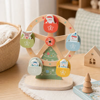 Christmas Ferris Wheel Wooden Toy with 5 Figurines shown on a real table surface
