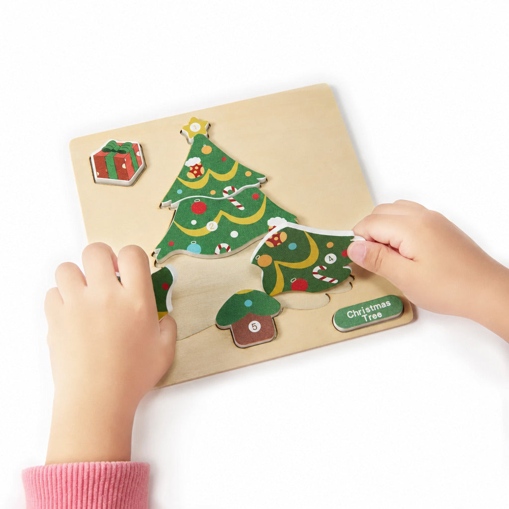 Child fitting the Christmas tree piece into the wooden puzzle board