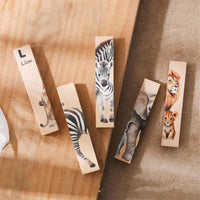 Animal puzzle blocks standing upright showing zebra and lion strips