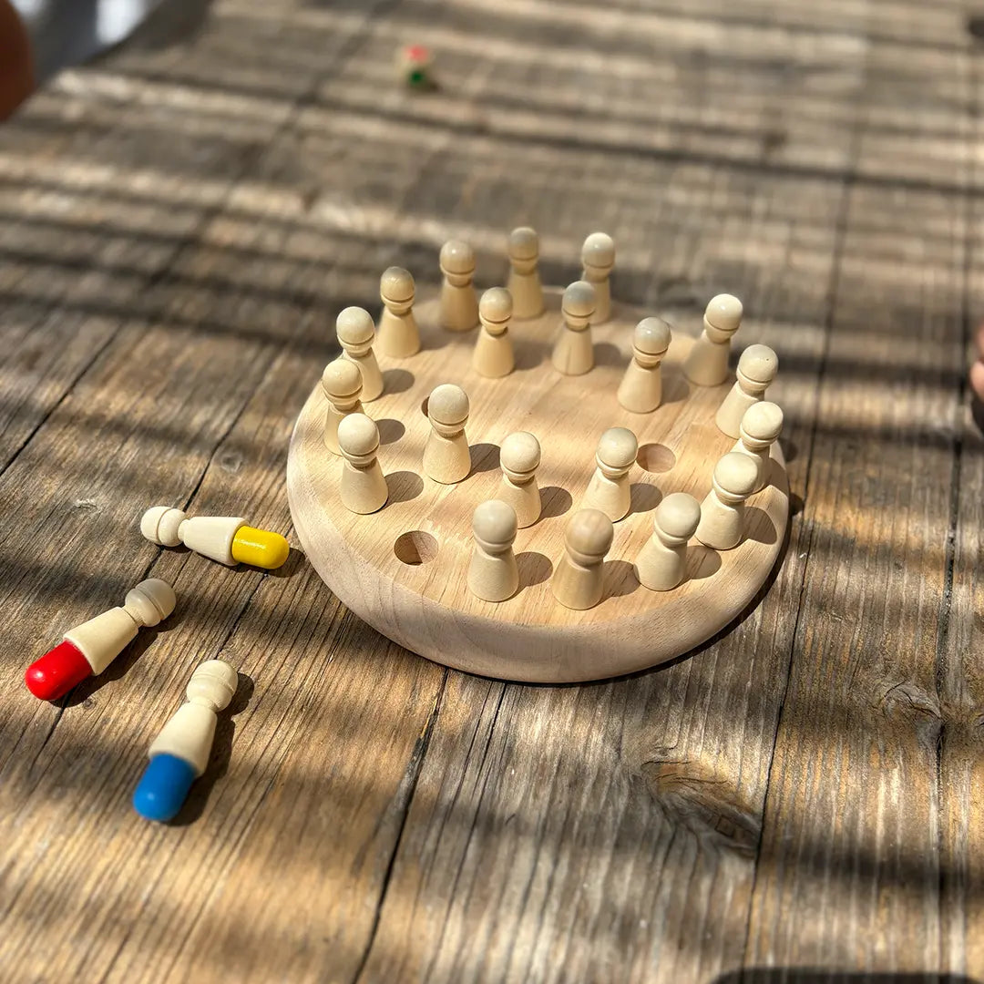 Wooden memory game disc with pegs on a rustic table