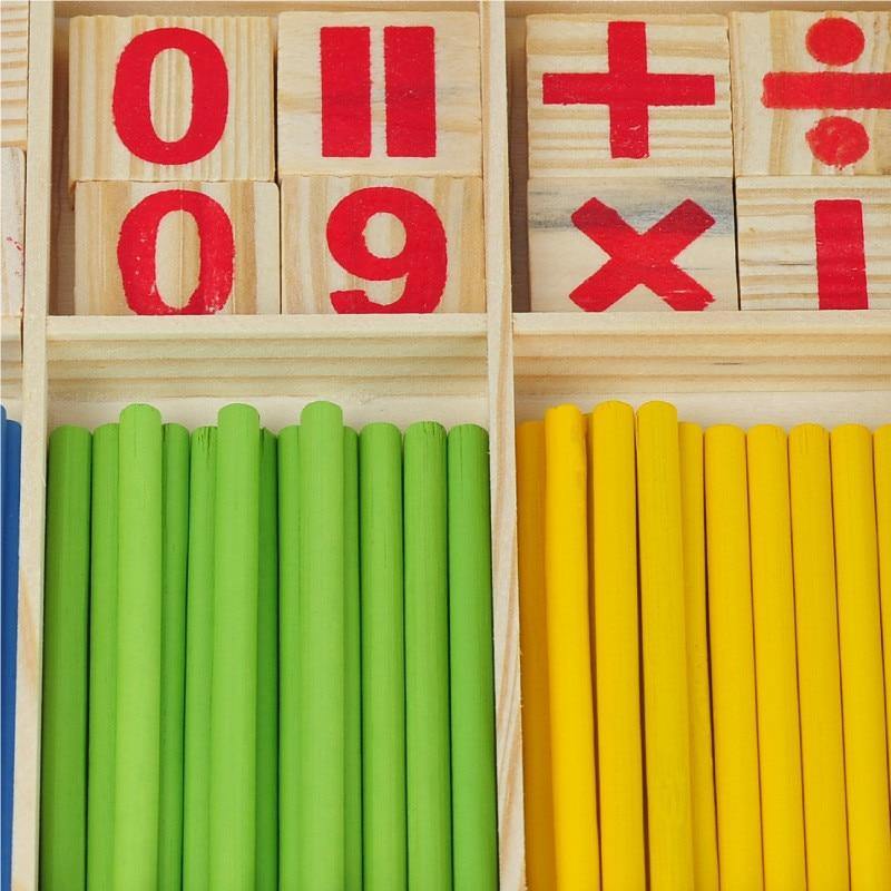 Wooden number and operator tiles above green and yellow counting sticks