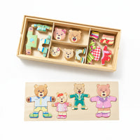 Bear dress-up puzzle pieces sorted in a wooden storage tray