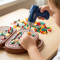 Boy drilling coloured pegs into the bear toolbox board