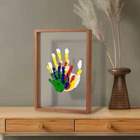 Handprint frame with a single child's handprint on a sideboard