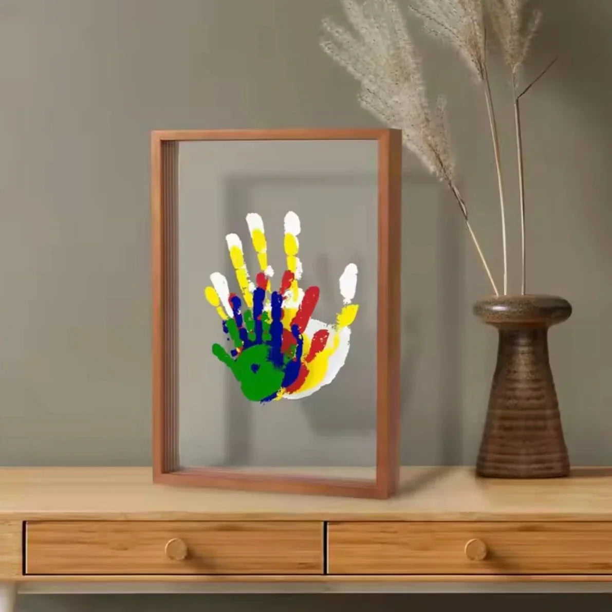 Handprint frame with a single child's handprint on a sideboard