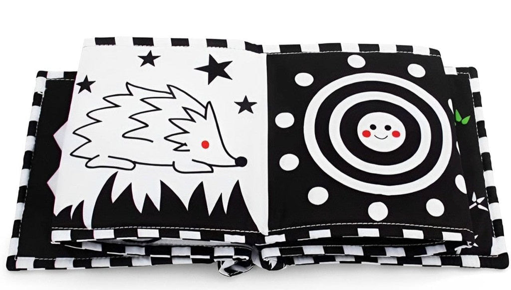 Black and white fabric book opened on hedgehog and spiral pages