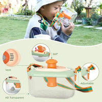 Boy outdoors drinking from a bottle beside the insect explorer viewer