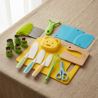 Kids cooking tool set laid out on a linen cloth with cutting boards