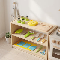 Kids cooking tools arranged on a wooden play kitchen shelf