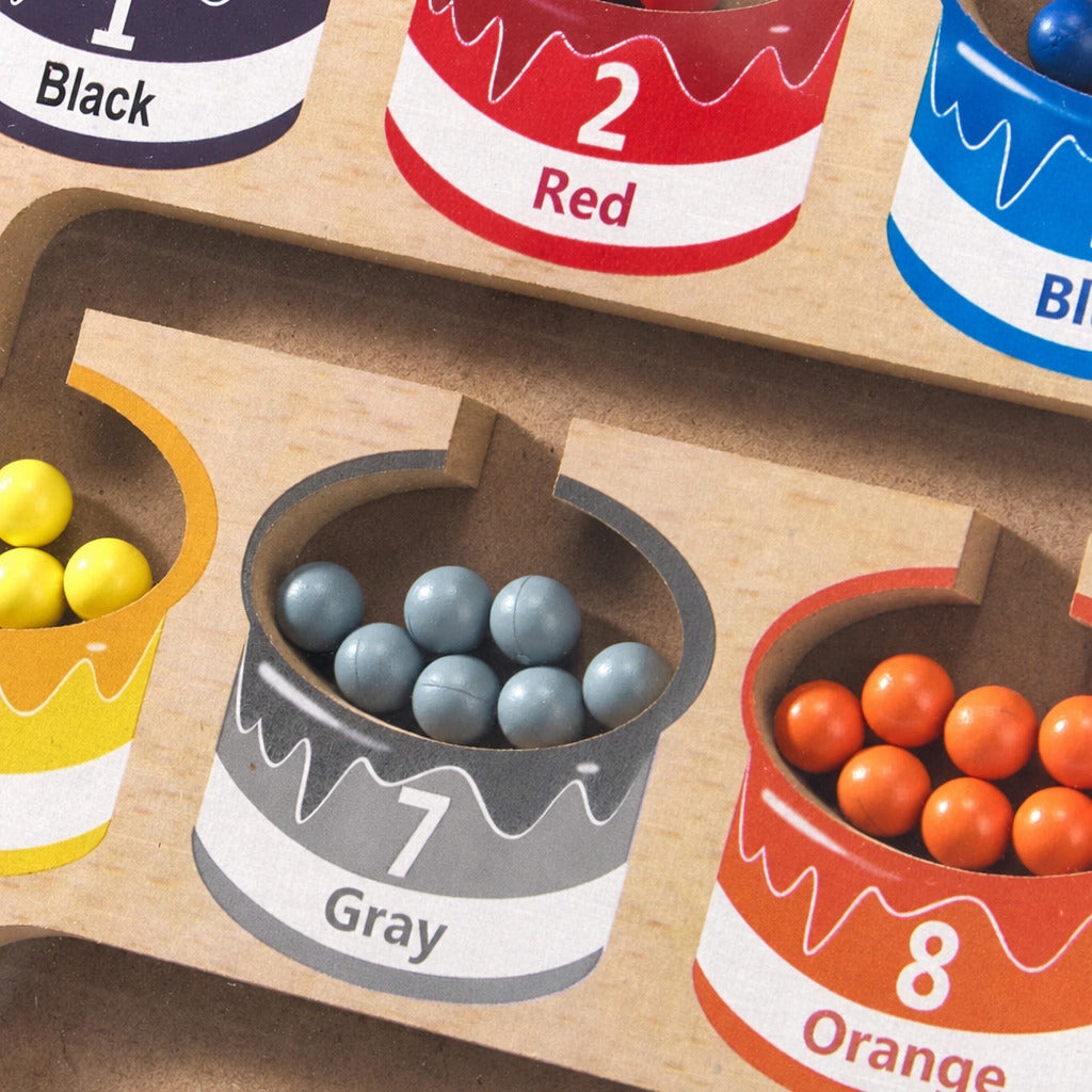 Colour maze board with numbered wells holding grey and orange beads