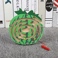 Green apple magnetic maze standing against a row of books