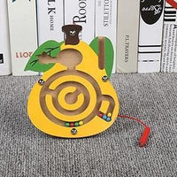 Yellow bear magnetic maze standing on a carpet beside books