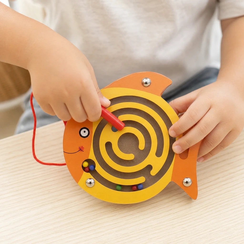 Close-up of a child's hands using the Magnetic Maze Toy Fish-Shaped Wooden Puzzle