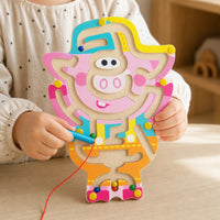 Close-up of a child's hands using the Magnetic Maze Toy - Wooden Pig Design