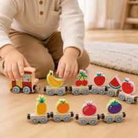 Close-up of a child's hands using the Magnetic Wooden Train with Fruit Cars
