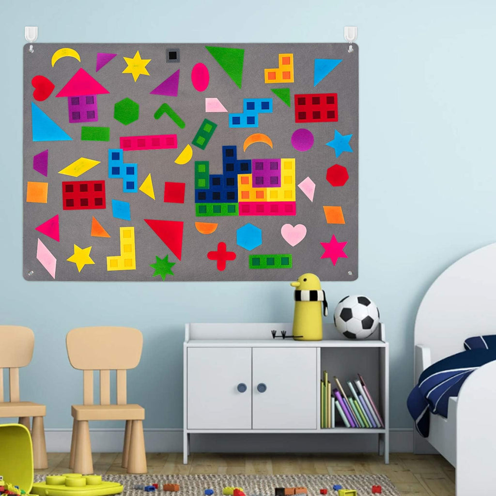 Felt board mounted on a playroom wall covered in coloured shapes