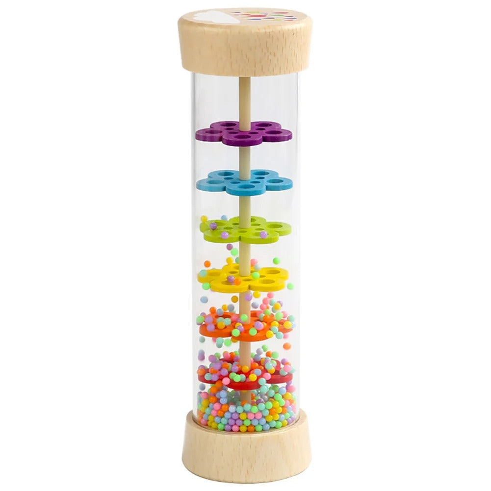 Wooden rainbow rainstick standing upright with coloured beads inside