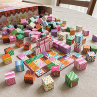 Candy House magnetic cubes spread on the table, build in progress