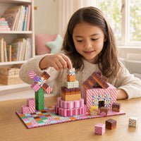 Child building the Candy House set with magnetic cubes