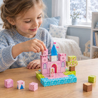 Child building the Snowy Pink Castle set with magnetic cubes