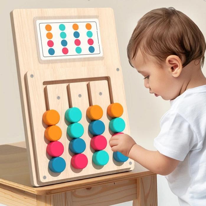 Toddler moving coloured discs on the pattern matching board