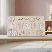 Pastel name puzzle spelling Charlie with butterfly and flower pieces