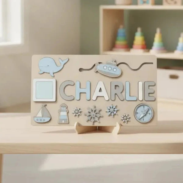 Blue-themed name puzzle spelling Charlie with whale and boat pieces