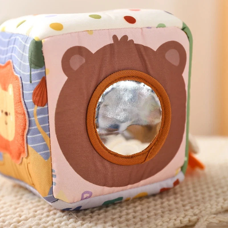 Sensory cube panel with a safety mirror set into the bear's face