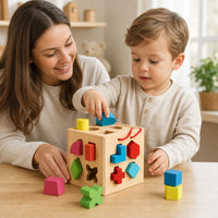 Child playing with the Shape Sorter Cube with Geometric Blocks