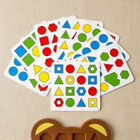Fanned pattern cards with coloured shapes beside the bear board