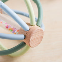 Close-up of the wooden hub joining the rattle's silicone arms