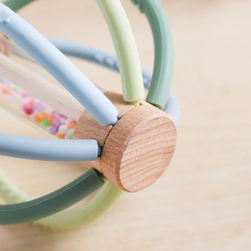 Close-up of the wooden hub joining the rattle's silicone arms