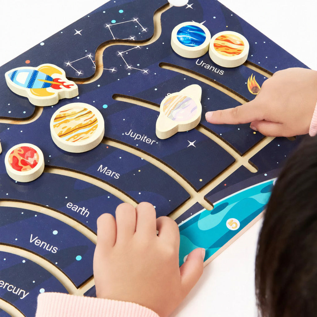 Child placing planet pieces on the constellation puzzle board