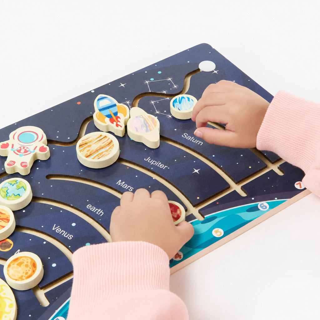 Two children completing the wooden solar system board together