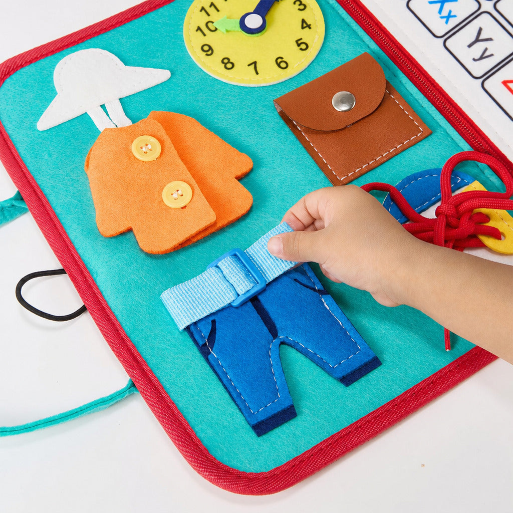 Child fastening the buckle on the open teal busy board